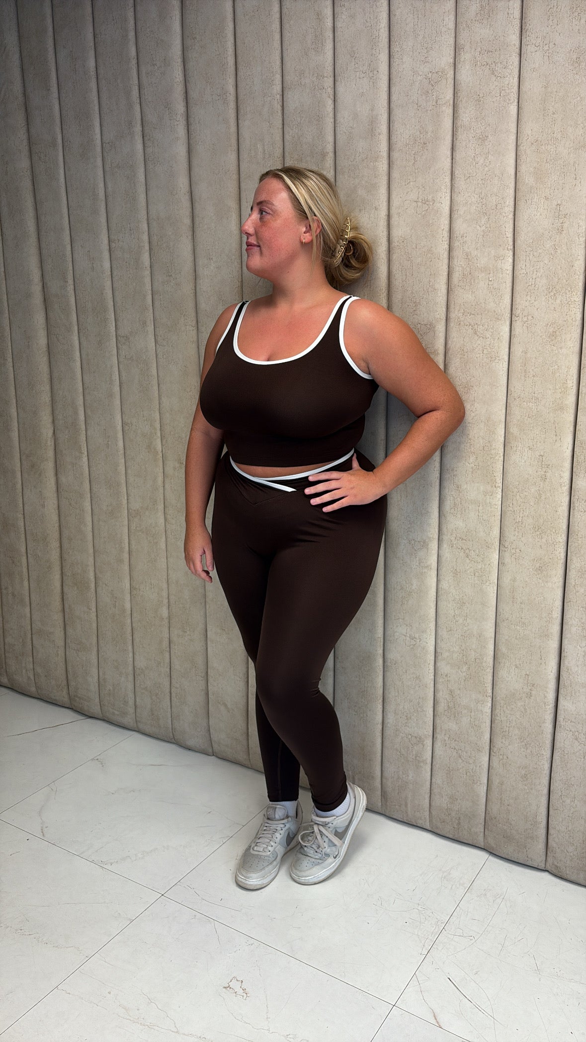 Brown gym set with white piping